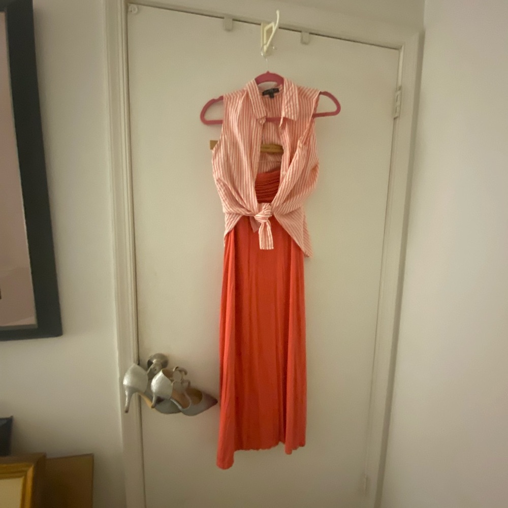 Orange striped sleeveless blouse with matching orange long skirt.